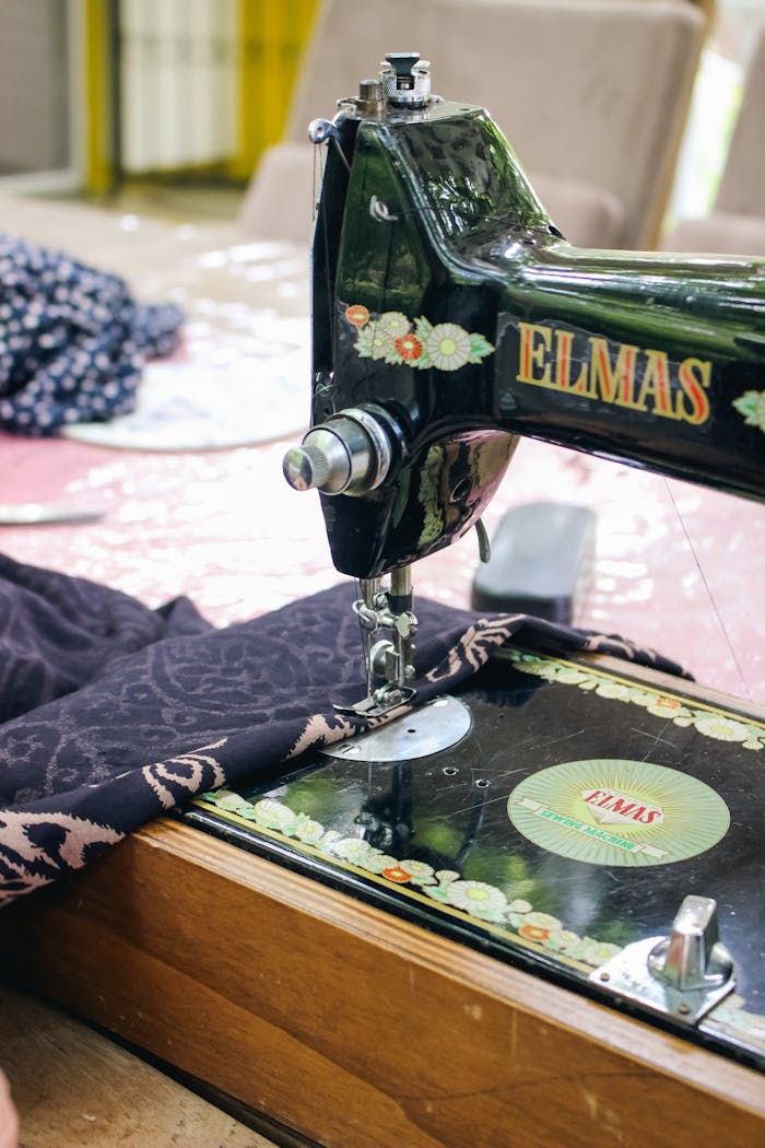 The Art of Drawing Readers In: Your attractive post title goes here Close-up of a vintage sewing machine with fabric in a tailor's workshop.